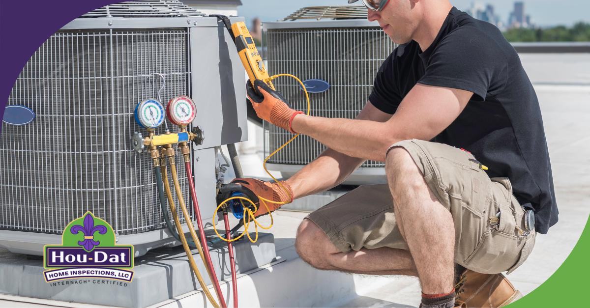 Technician using a multimeter and gauges to inspect an HVAC unit on a rooftop.